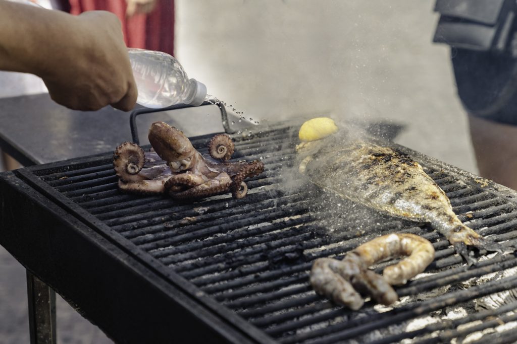 Grill mit Oktopus, Fisch und Wurst auf einem Markt in Palermo.