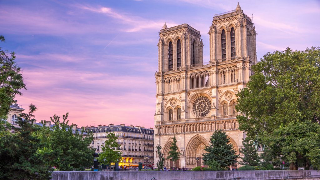 Die Kathedrale Notre-Dame in Paris vor einem rosa-violetten Abendhimmel.