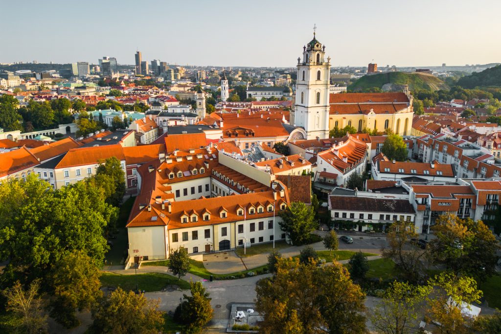 Rote Dächer, Kirchtürme und ein Hügel mit Turm prägen die historische Silhouette der Stadt.