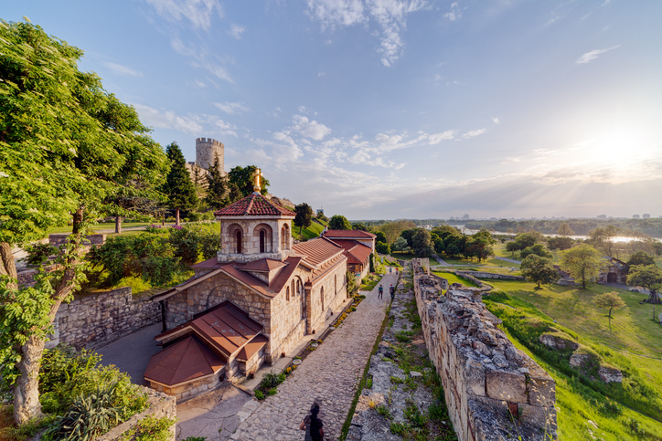 Eine kleine Steinkirche mit Ziegeldach steht innerhalb der historischen Festungsanlage von Belgrad über dem Zusammenfluss von Save und Donau.