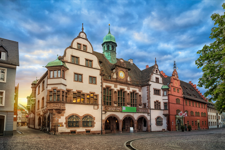 Fassade des Alten Rathauses in Freiburg mit seinen verzierten Giebeln und dem markanten Uhrturm.