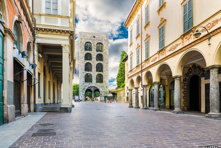 Der mittelalterliche Turm Porta Torre in der Fußgängerzone von Como zwischen historischen Gebäuden