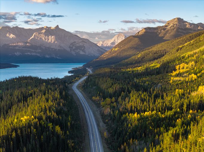 Eine Straße führt durch Wälder, Berge und Seen in den Rocky Mountains von Kanada.