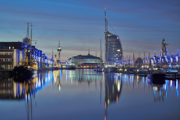 Beleuchteter Neuer Hafen mit Schiffen und Sail City in Bremerhaven