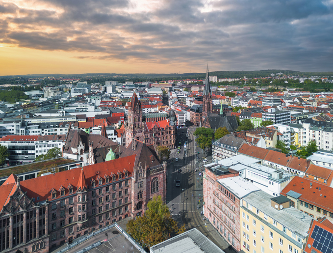 Panoramablick über Saarbrücken mit historischen Gebäuden, Kirchtürmen und dicht bebautem Stadtzentrum.